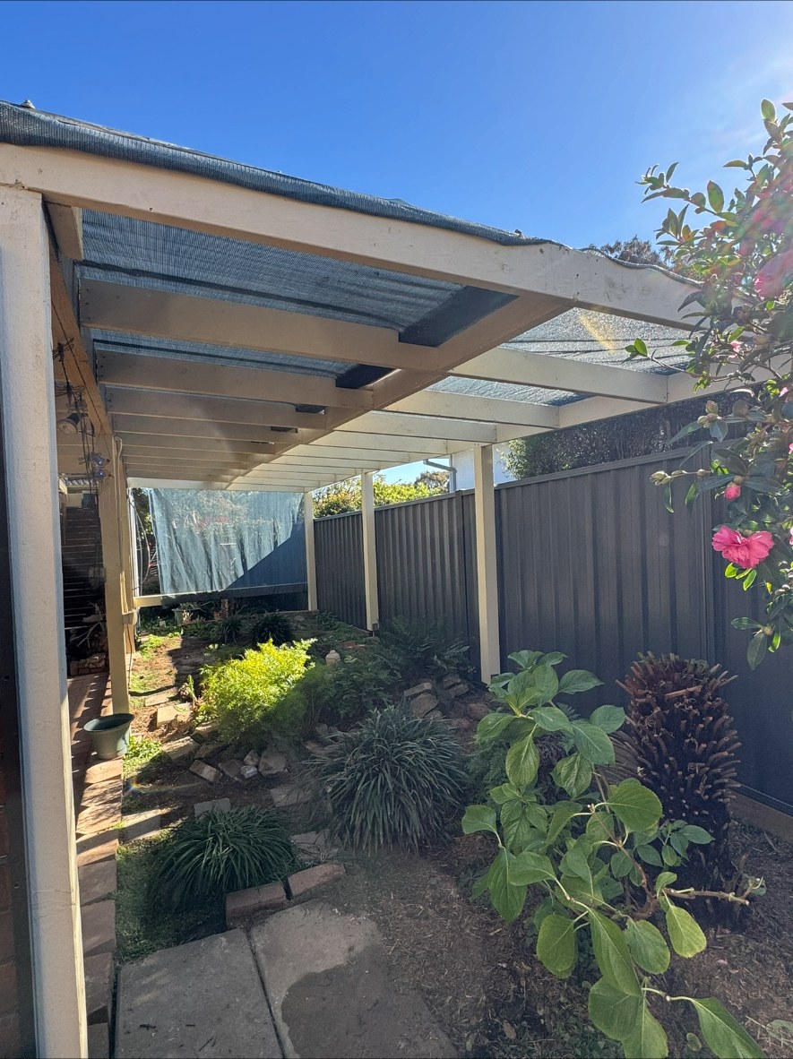 Existing timber pergola with shadecloth roof before replacement