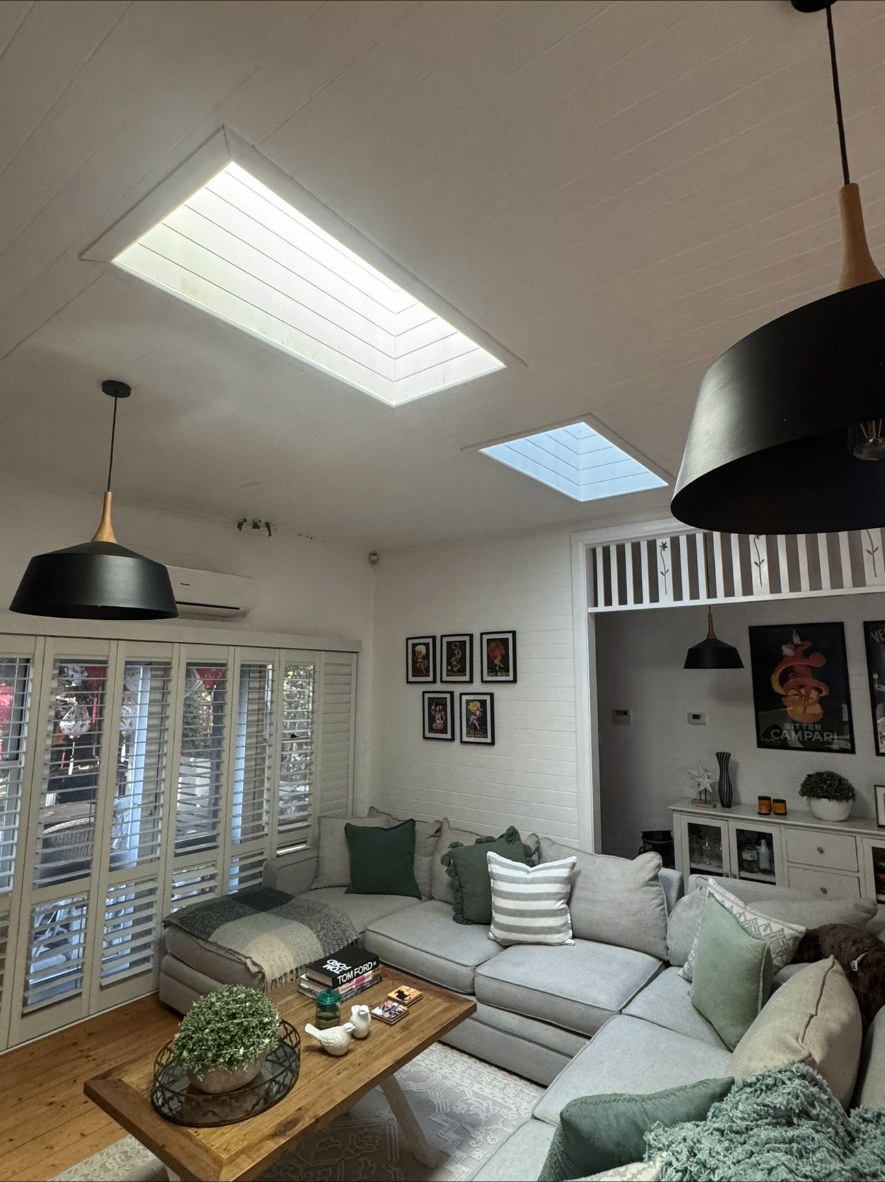 Living room with two skylights set into a lined ceiling