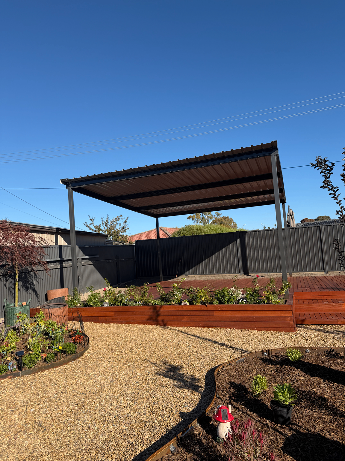 Steel pergola, hardwood deck and raised timber garden bed
